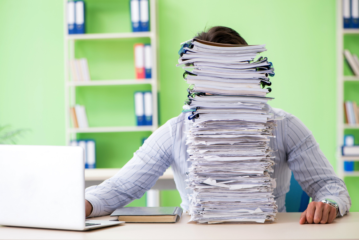 Businessman with Paperwork and Workload